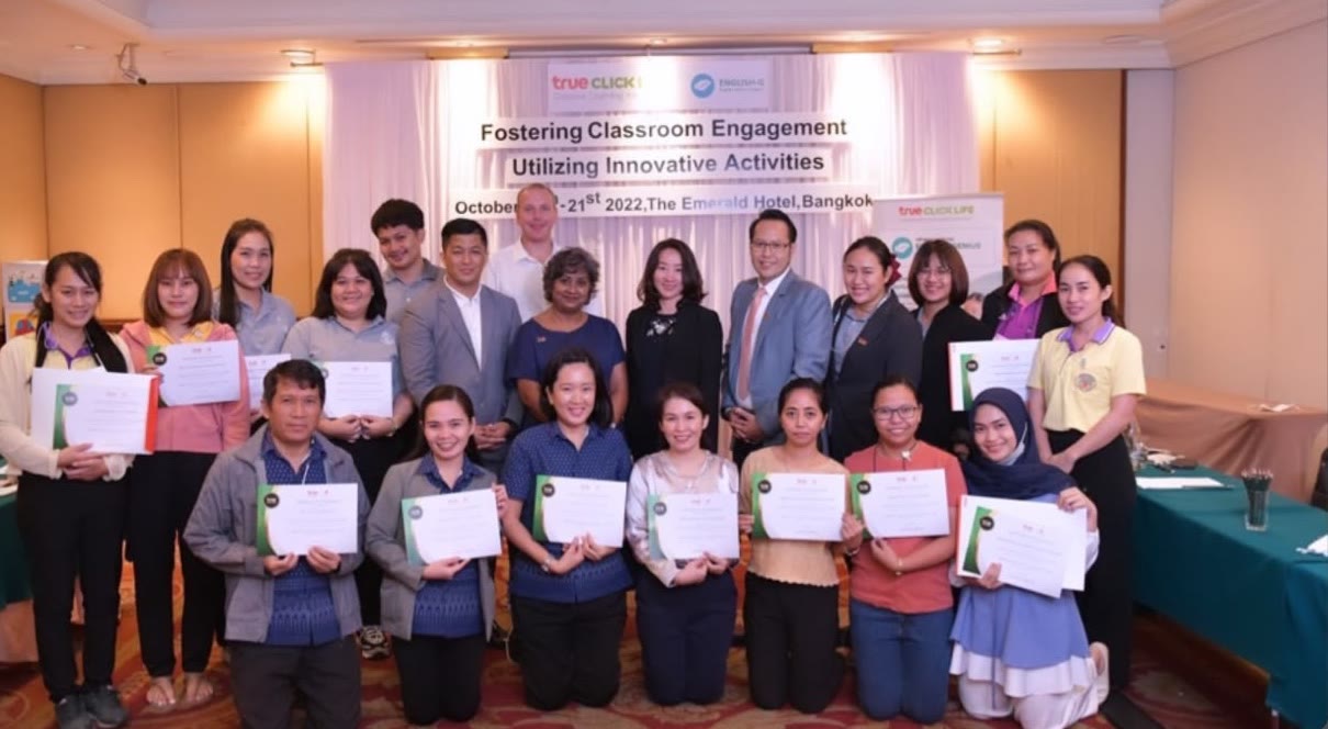 Teacher Dila with fellow teachers holding certificates at a training in Bangkok